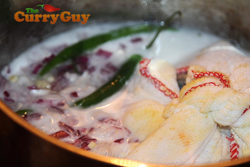 Making mackerel and mango curry